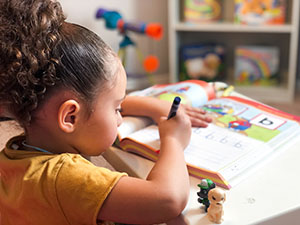 Preschooler writing alphabet