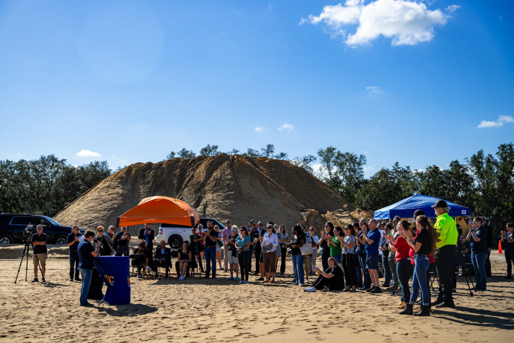 OCLS Chief of Neighborhood Services Danielle King speaks to a group gathered at the Horizon West Branch groundbreaking event on a clear, blue day.