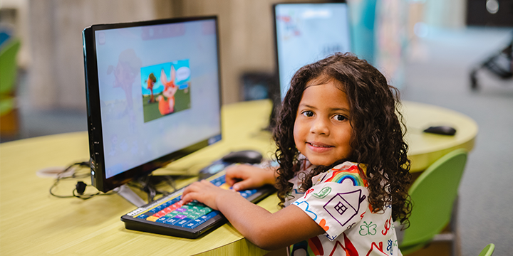 A child sitting at a computer.