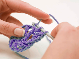 Close up of hands crocheting