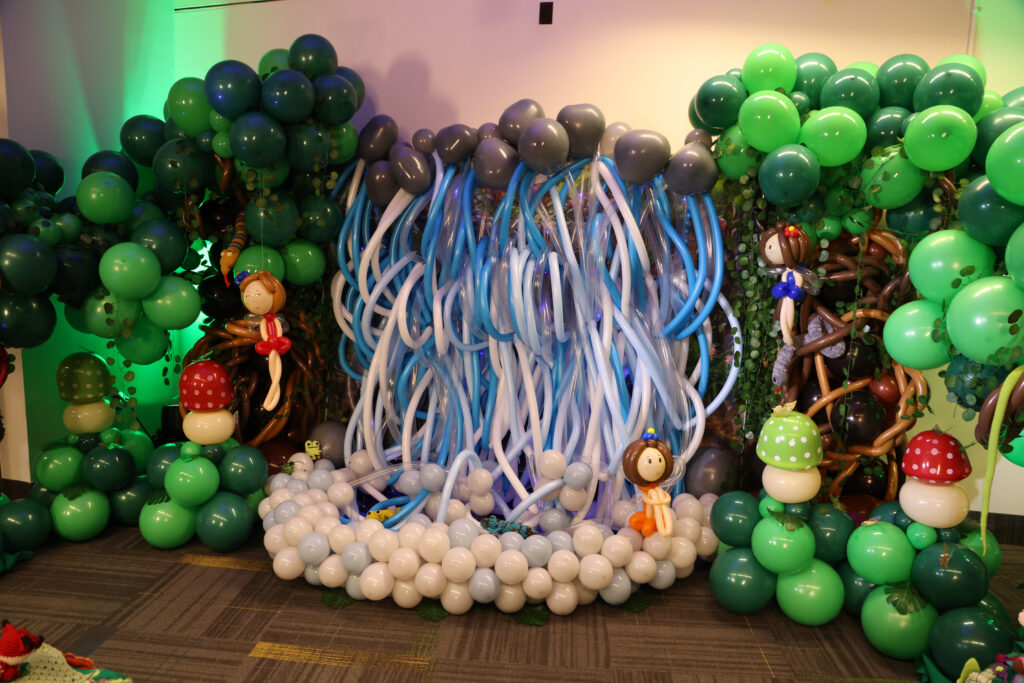 balloon art installation with trees, a waterfall, mushrooms and fairies