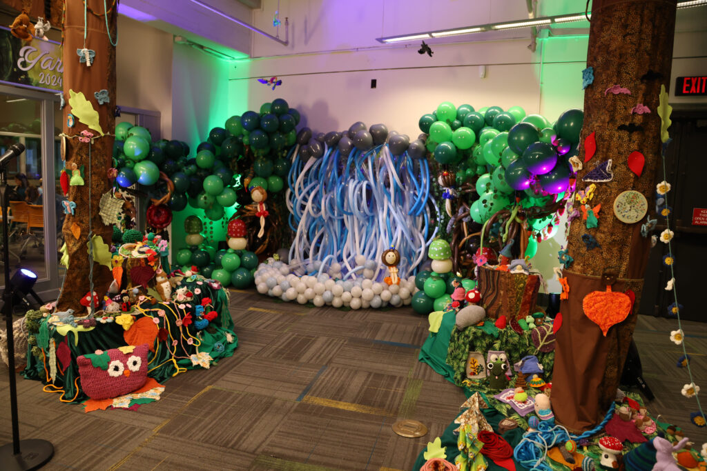 A fabric and balloon art installation with an enchanted forest theme