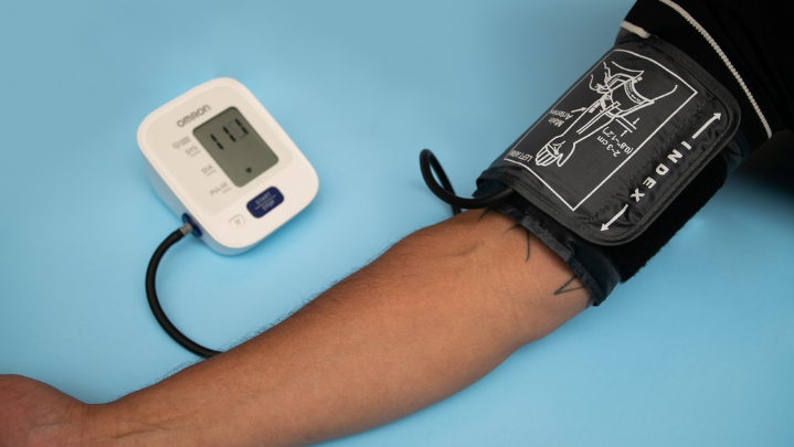 An arm is seen with a blood pressure monitor.