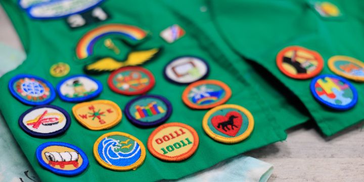 Green Girl Scout vest with embroidered patches