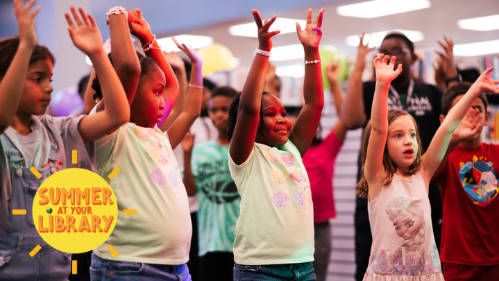 A group of children raise their hands in celebration for the end of summer!