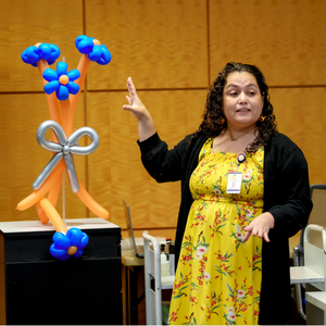 OCLS staff member Ivonne teaches a balloon art class