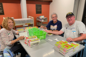 Friends of the Library volunteers work to process book donations