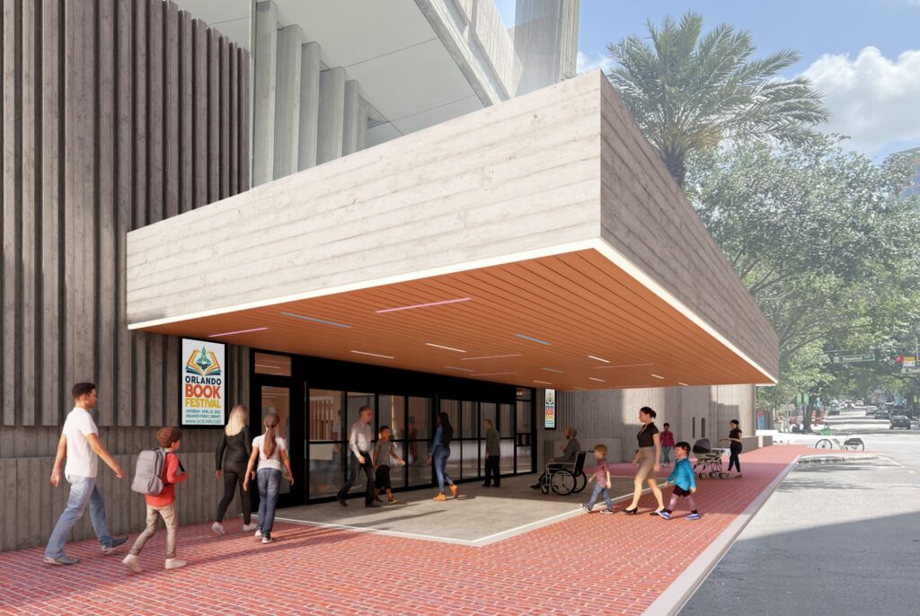 Contemporary library entrance featuring a wide wooden canopy over glass doors, with several people entering and walking along a red brick sidewalk lined with trees; a sign near the entrance reads “Orlando Book Festival